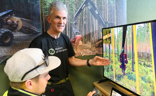 Swedish forestry tutor Anders Öberg shows student Bradley Solomon, new functions on one of Toi Ohomai’s harvesting simulators