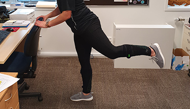 A person exercising at their desk