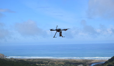 Drone flying above coastal land