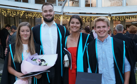 Graduates pose for a photo