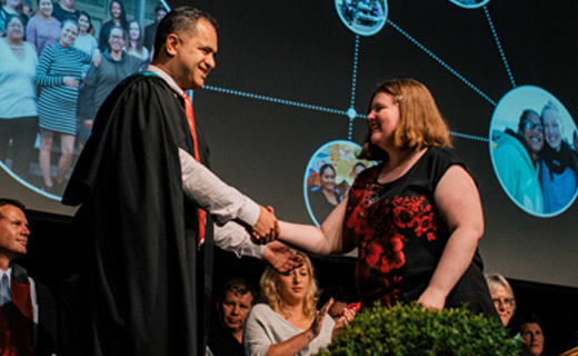 Graduate receiving certificate from tutor