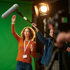 Tutor teaching students on set