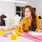 Creative Design student measuring out fabric