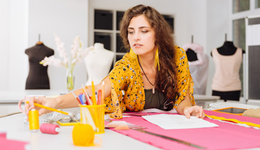 Creative Design student measuring out fabric