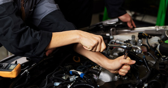 Automotive student working on a car