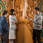 Students learning about the carvings in Tangatarua Marae