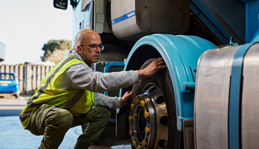 Student checking wheel on truck Student checking wheel on truck