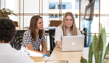 Computing students looking at a laptop Computing students looking at a laptop