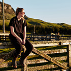 Farming student sitting on a fence Farming student sitting on a fence