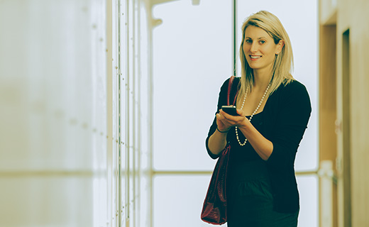 Communications student using her mobile phone